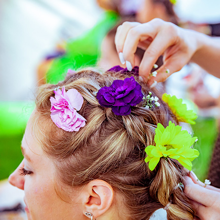 Woman Getting Flowers Placed in Her Hair