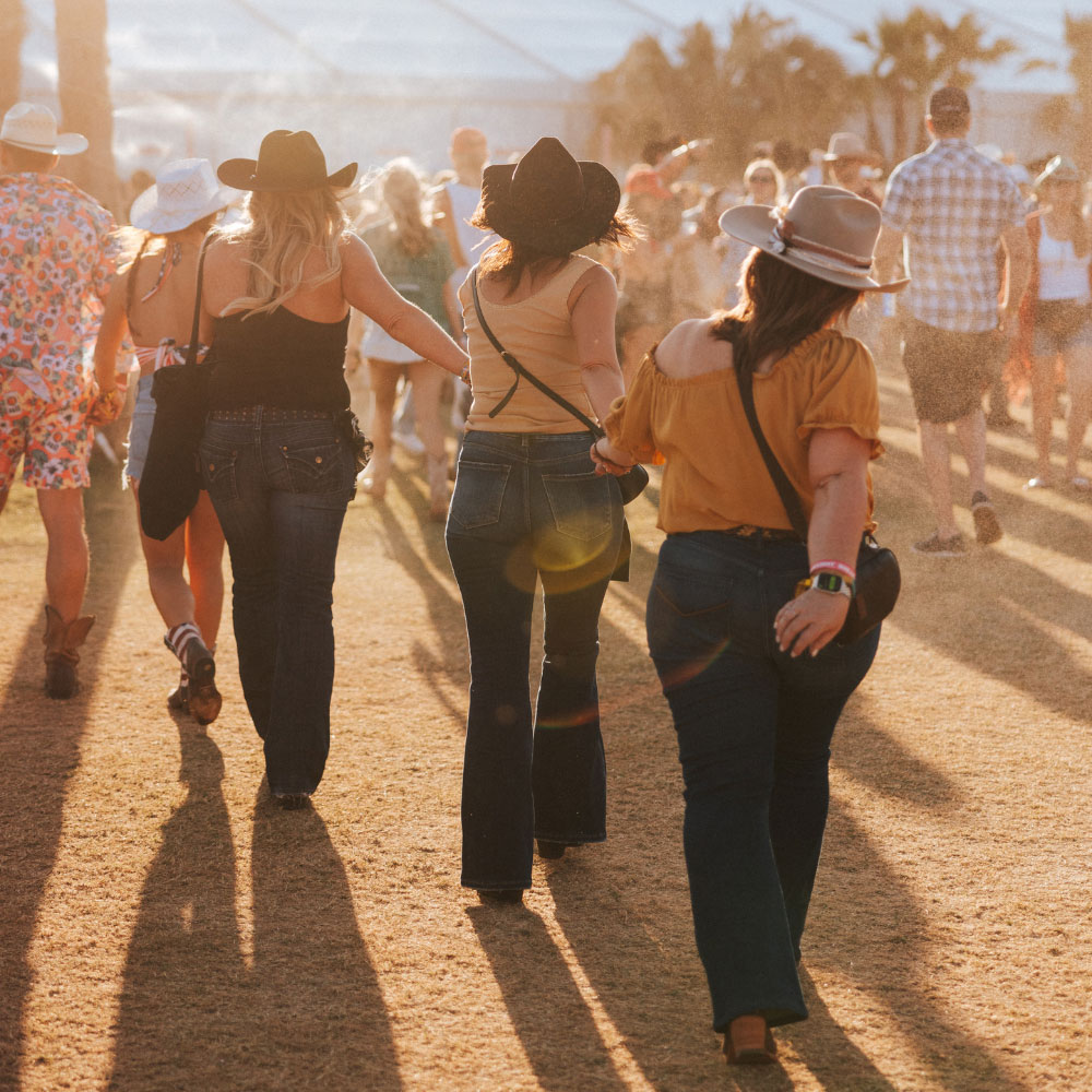 Candid photo of Stagecoach fans walking through field