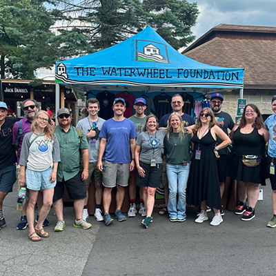 People in Front of WaterWheel Tent