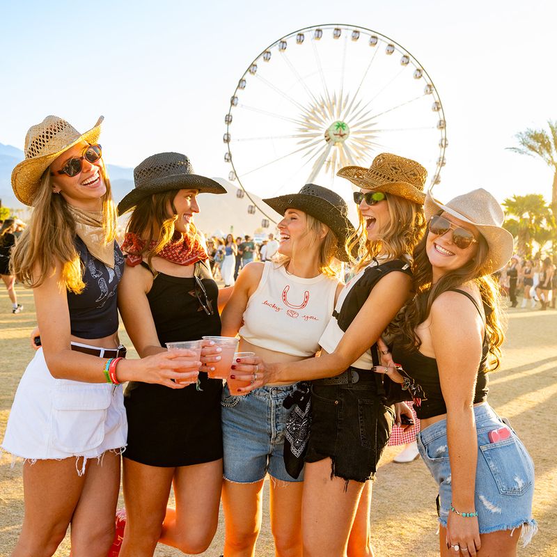 friends posing in front of the ferris wheel