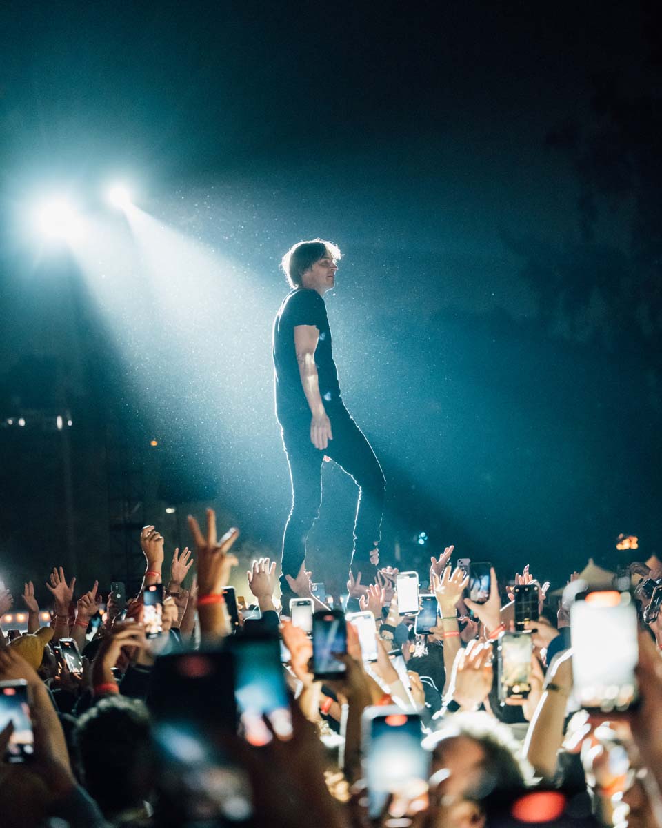 Person Performing Above Crowd