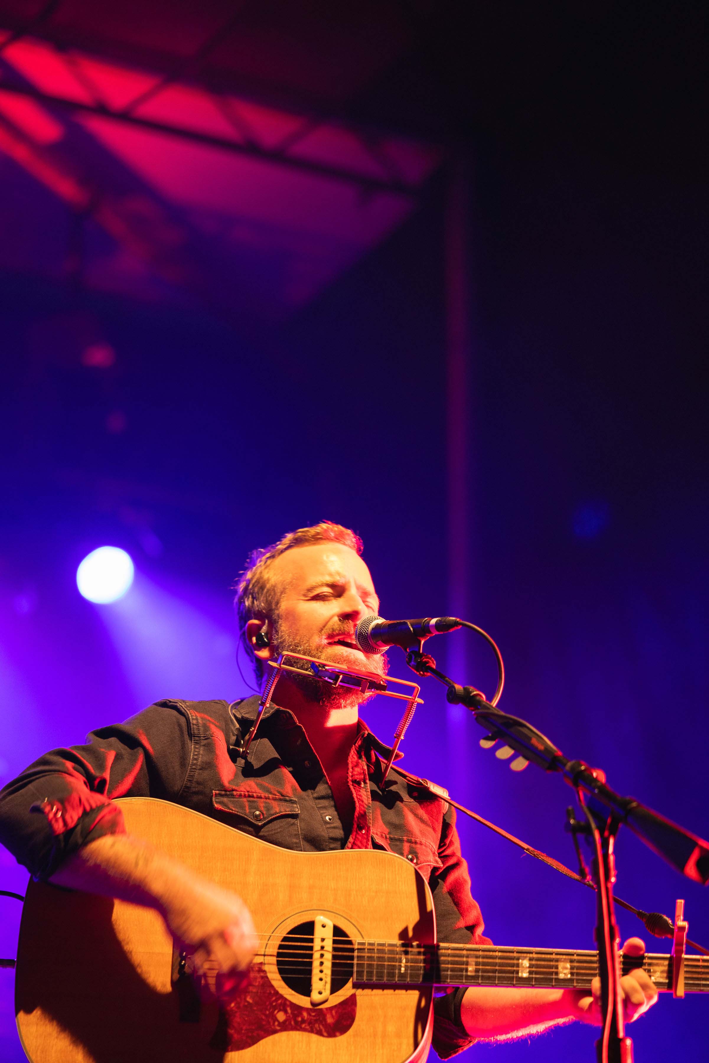 man playing guitar and singing