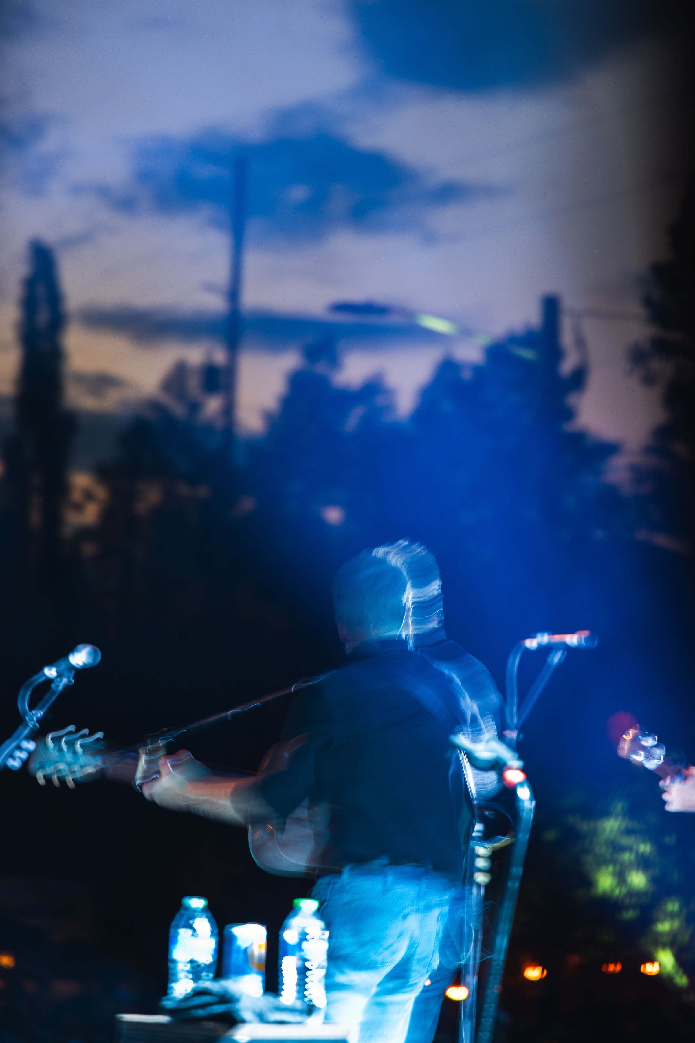 man performing on stage at night