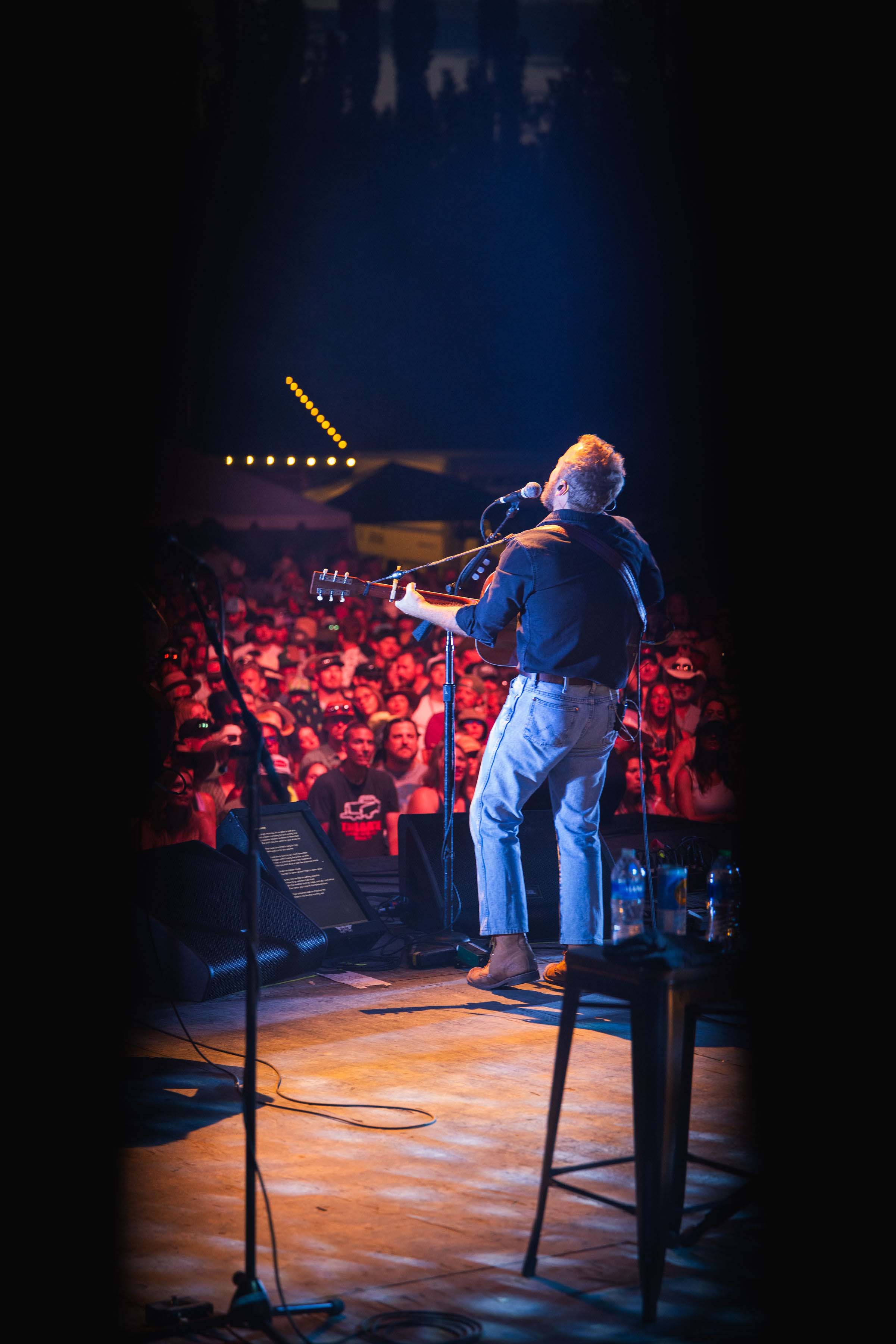 man performing on stage at night