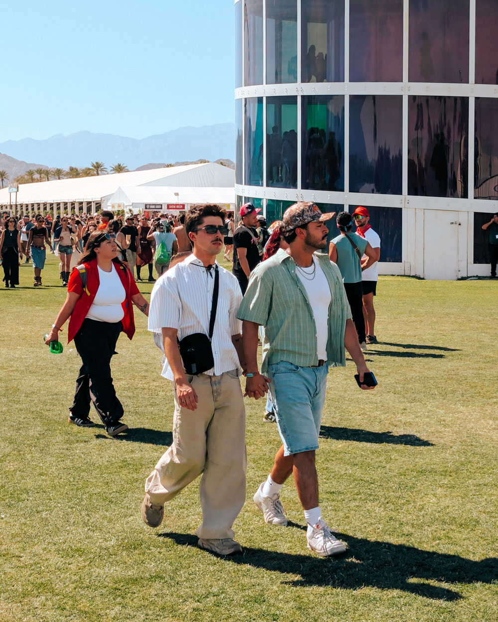 a couple walking front of Coachella tower