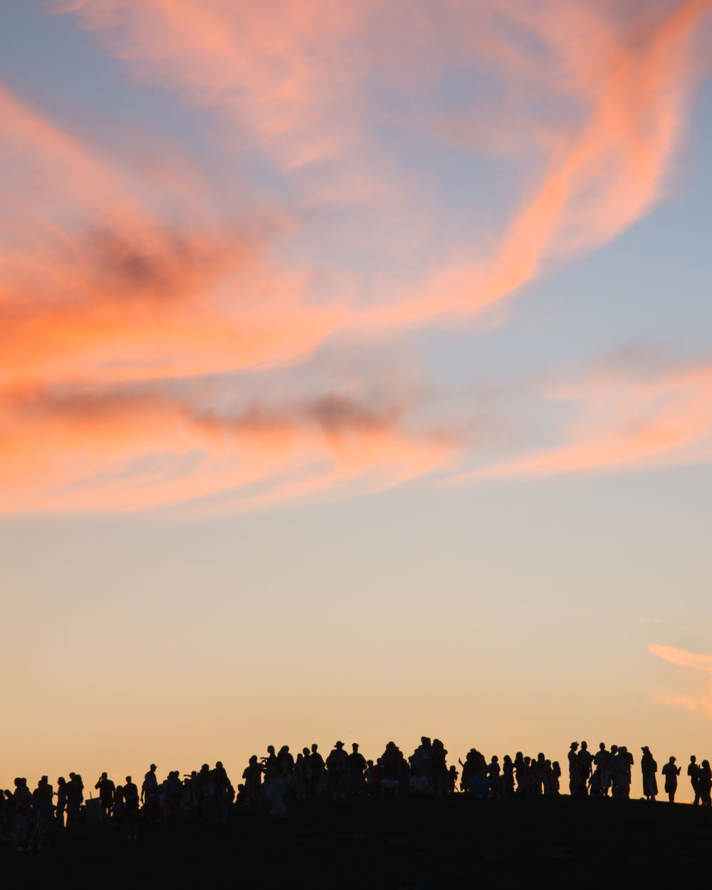 fans on hill at sunset