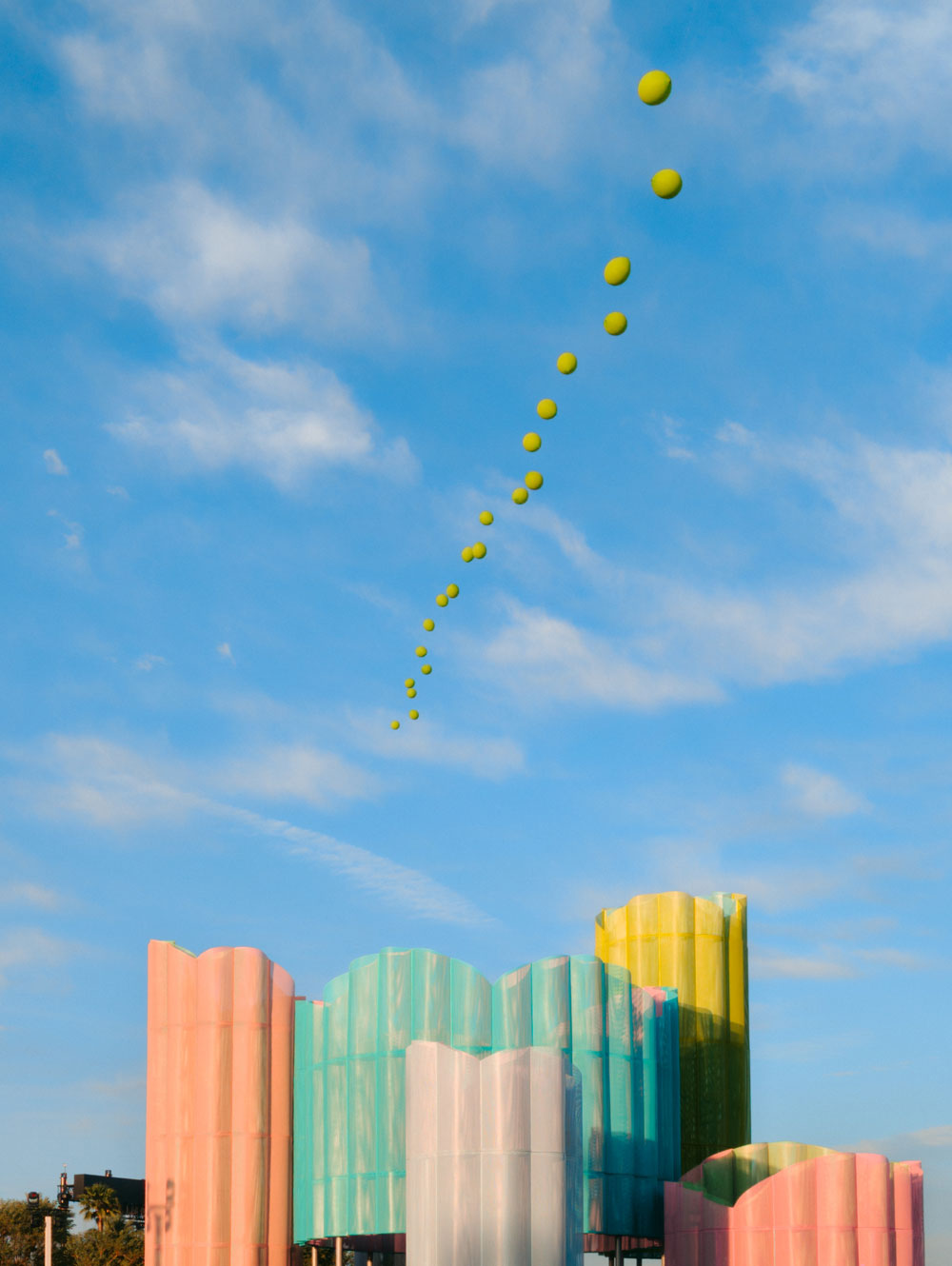 balloon chain against clouds and blue sky