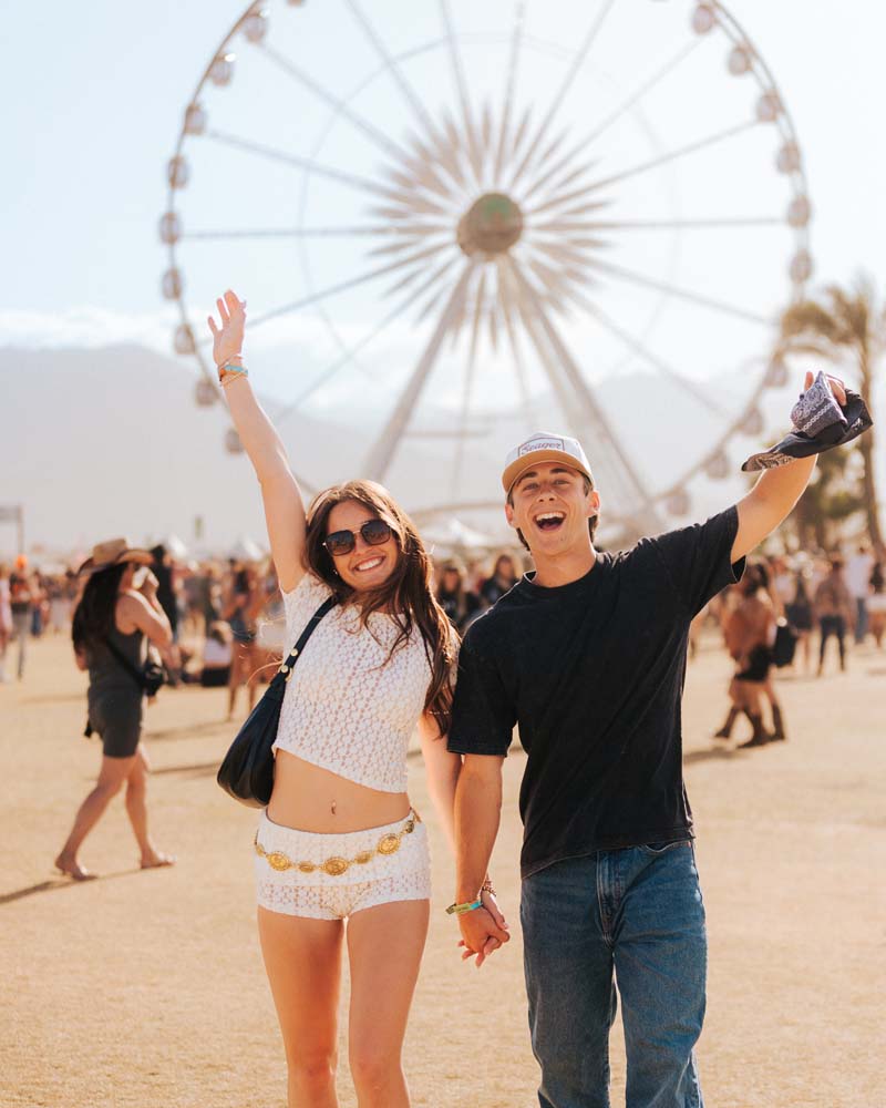 couple posing in front of the ferris wheel