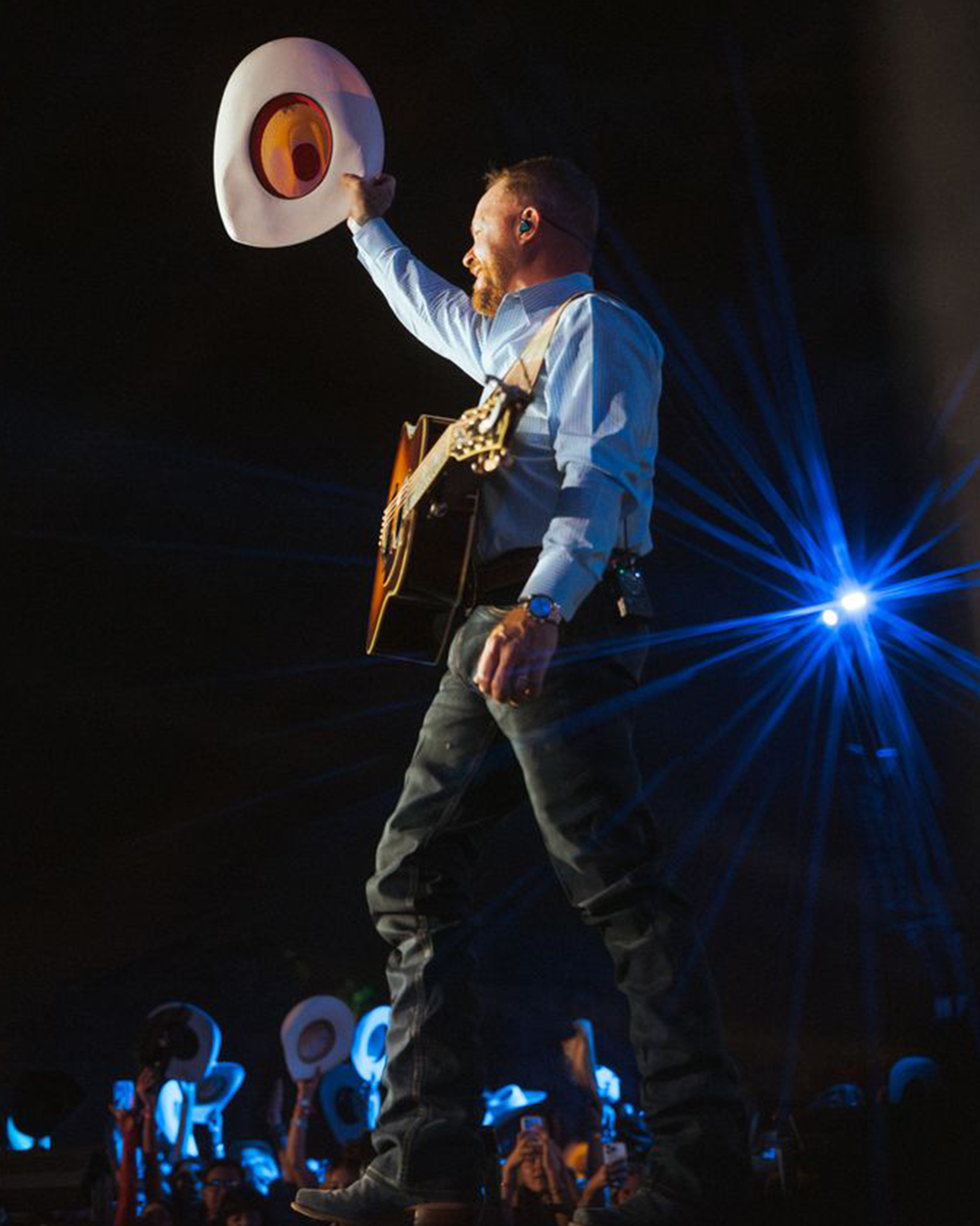 performer waving his hat