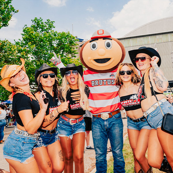 Girls posing around mascot