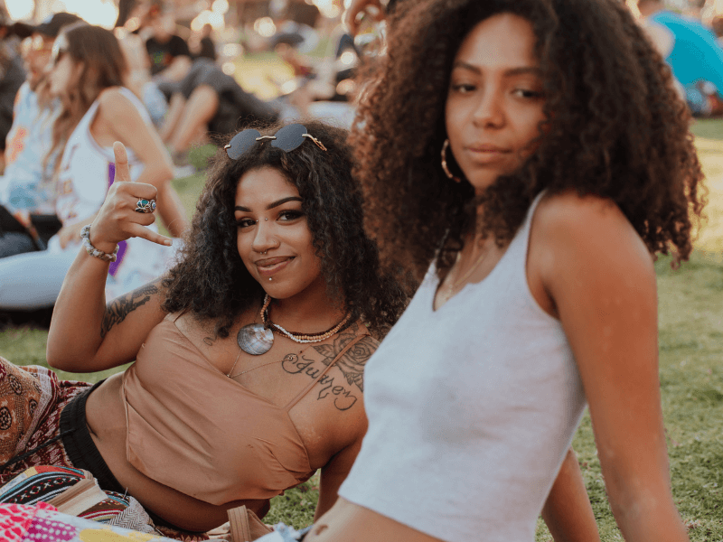 Two attendees hanging out on the grass