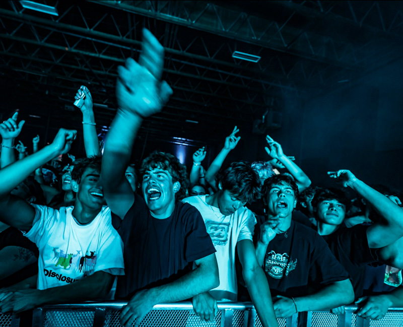 Guests in blue light dancing at The Complex