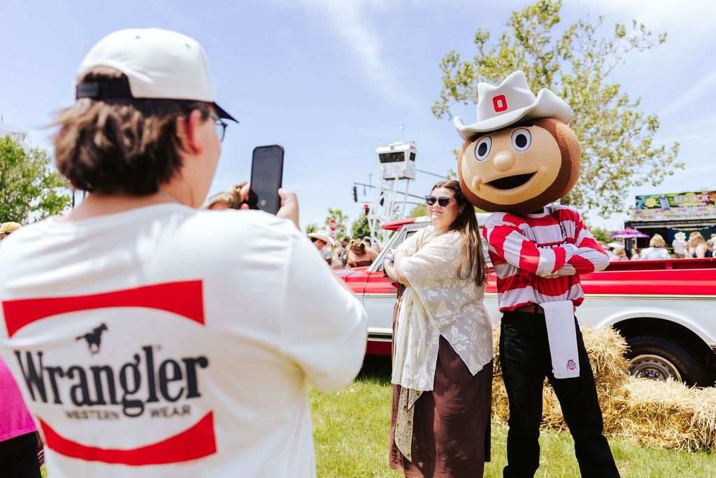 attendees posing with mascot